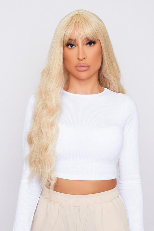 Beautiful lady wearing blonde wavy synthetic wig with bangs