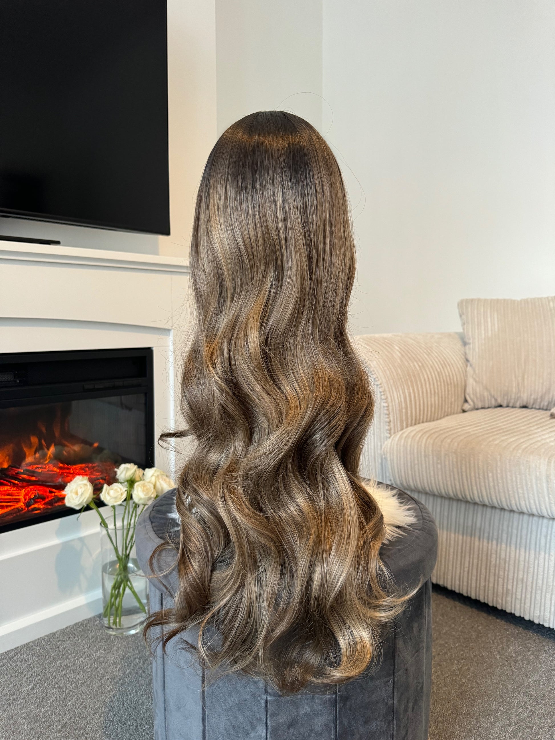 Back view of a 24-inch wavy balayage wig, emphasizing the soft waves and natural color gradient