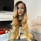 product Close-up of a synthetic honey blonde wig with a lace front, highlighting the rich color and realistic hairline