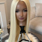 Close-up of a synthetic long blonde wig with a lace front, highlighting its elegant color and seamless fit