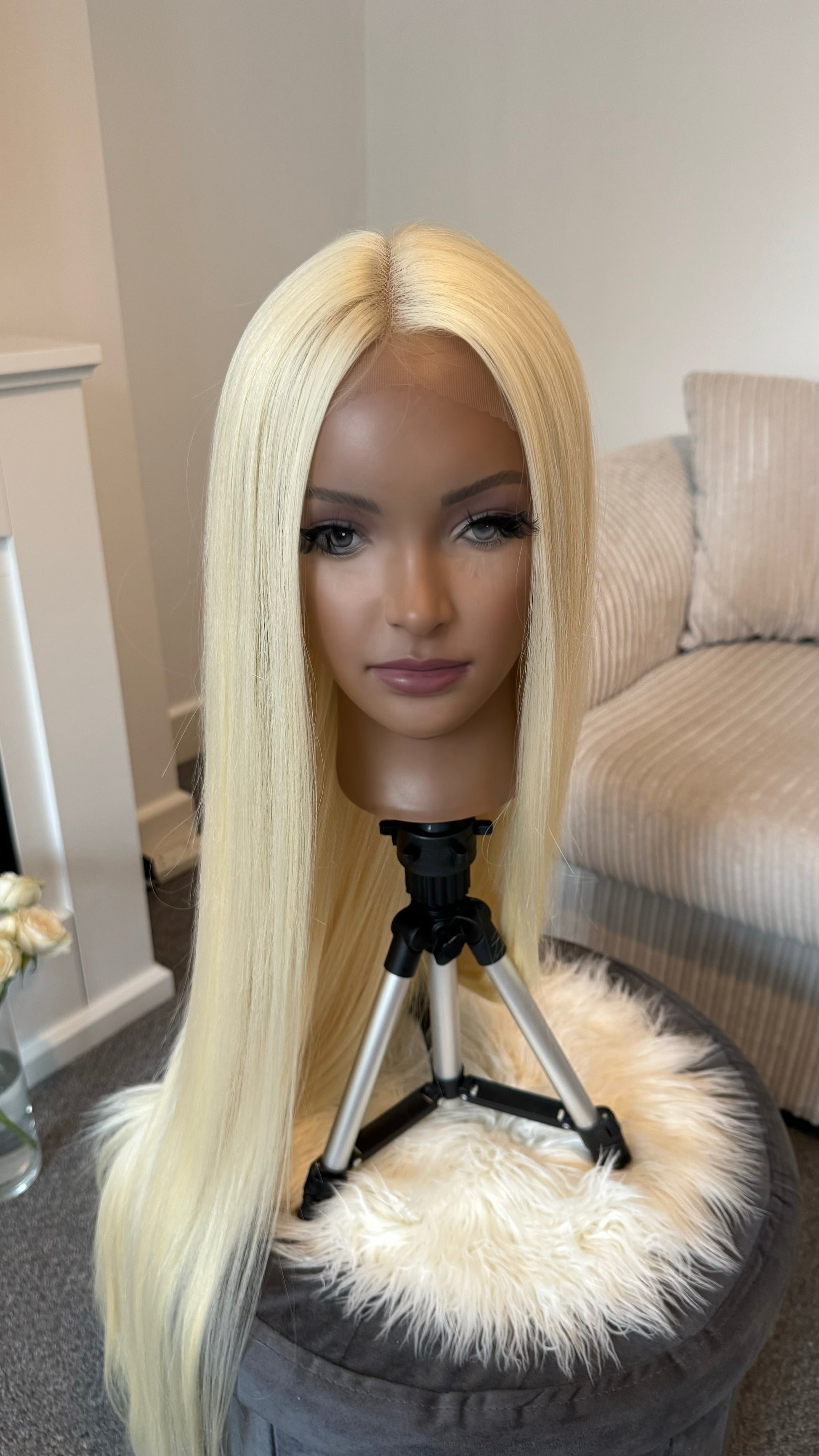 Close-up of a synthetic long blonde wig with a lace front, highlighting its elegant color and seamless fit