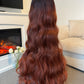 Back view of a 36-inch long wavy auburn wig, emphasising the flowing waves and vibrant colour