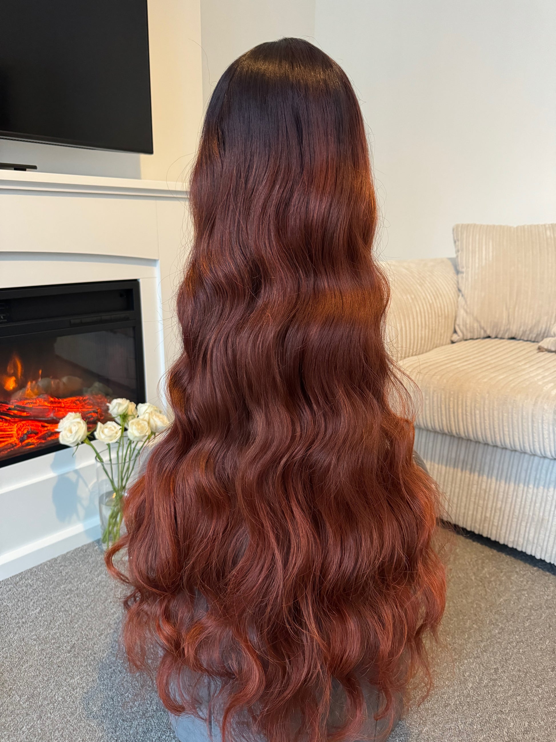 Back view of a 36-inch long wavy auburn wig, emphasising the flowing waves and vibrant colour