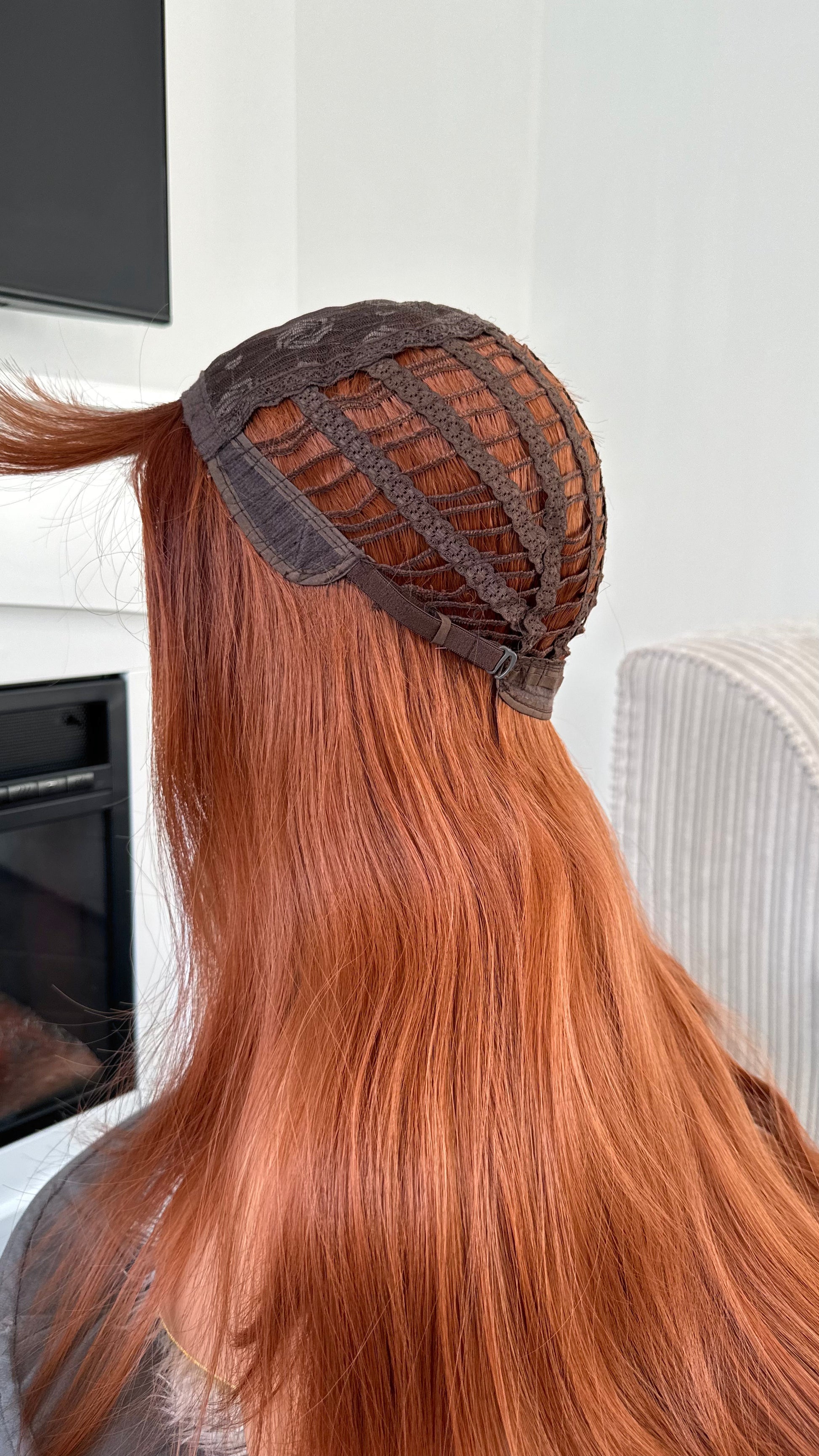 Lightweight and breathable synthetic wig in bold ginger tones.