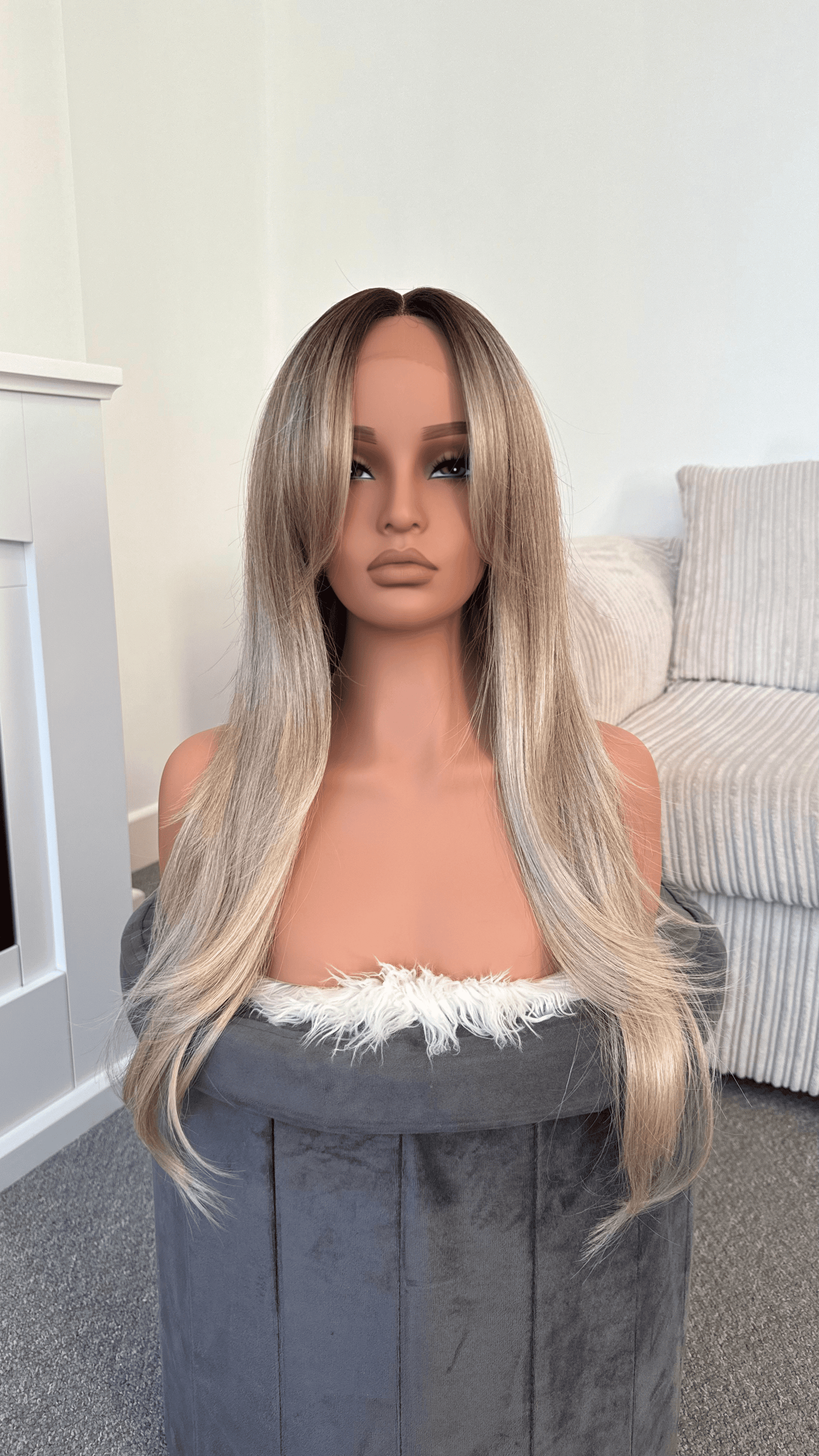 Synthetic wig featuring ash blonde tones and a breathable lace front.