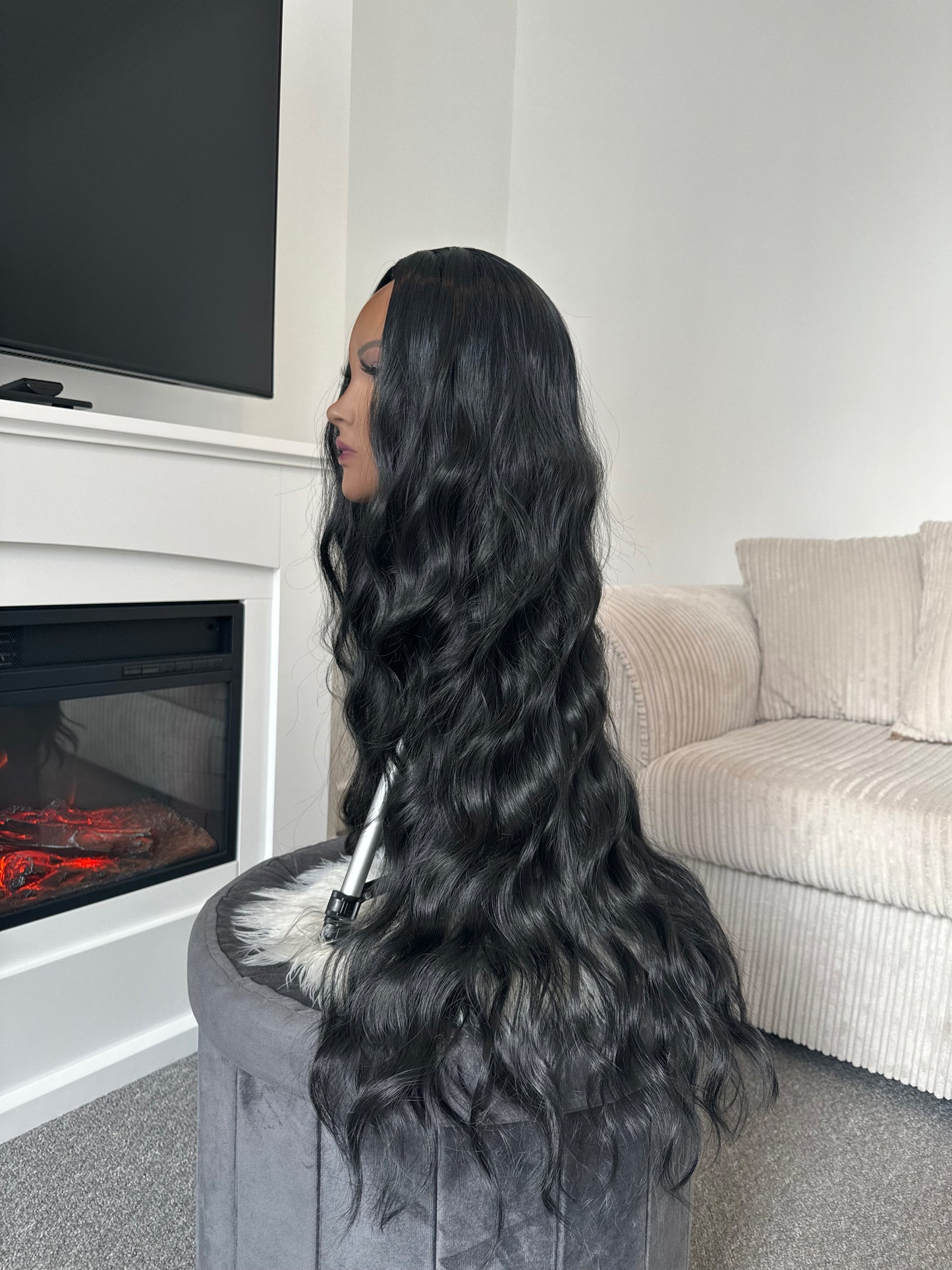 Side view of the 28-inch black synthetic hair wig with wavy texture and long length