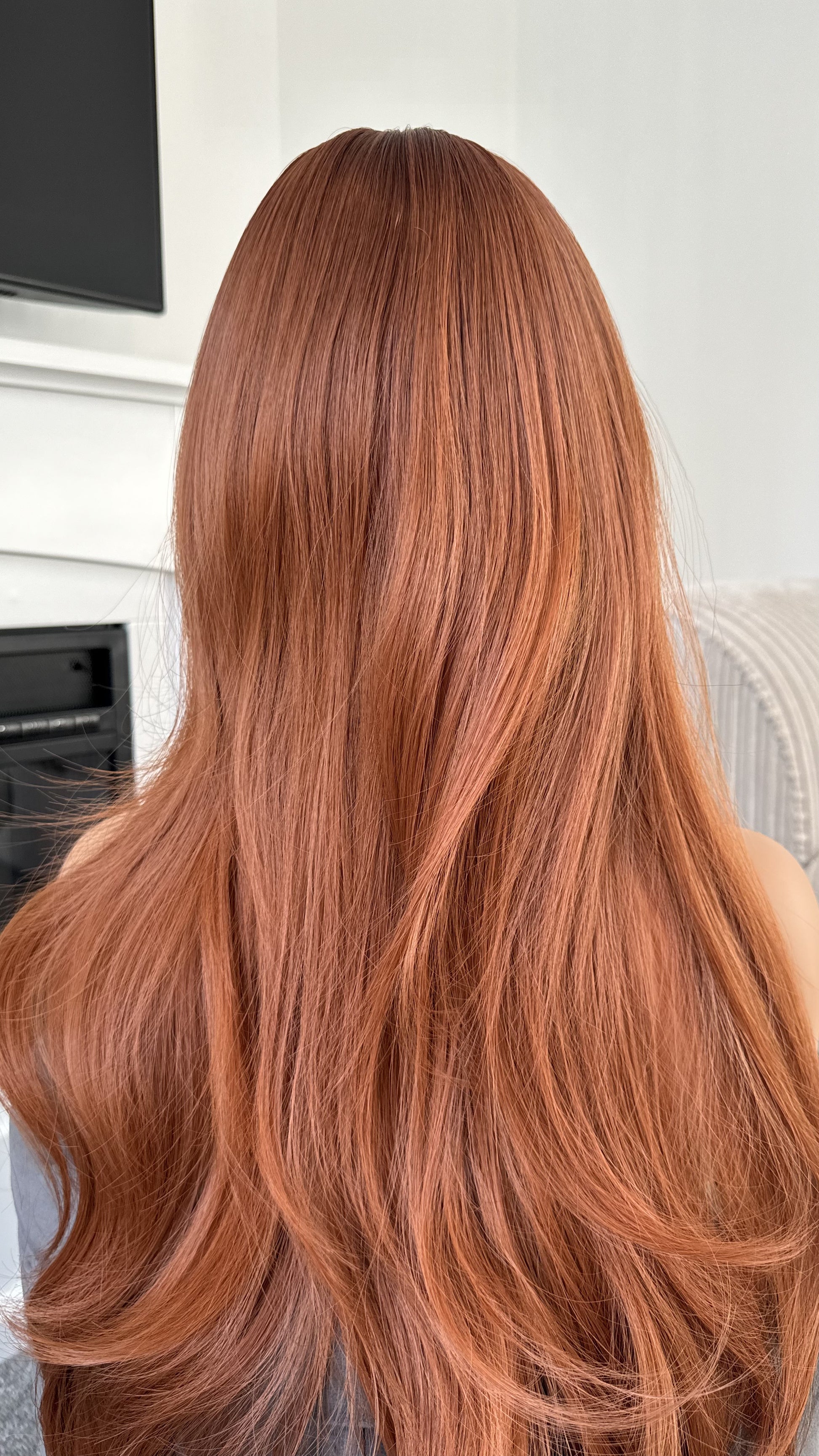 Back view of ginger hair wig highlighting smooth texture and shine.