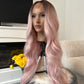 Side view of a wavy pink wig with a lace front, showcasing the soft waves and natural finish