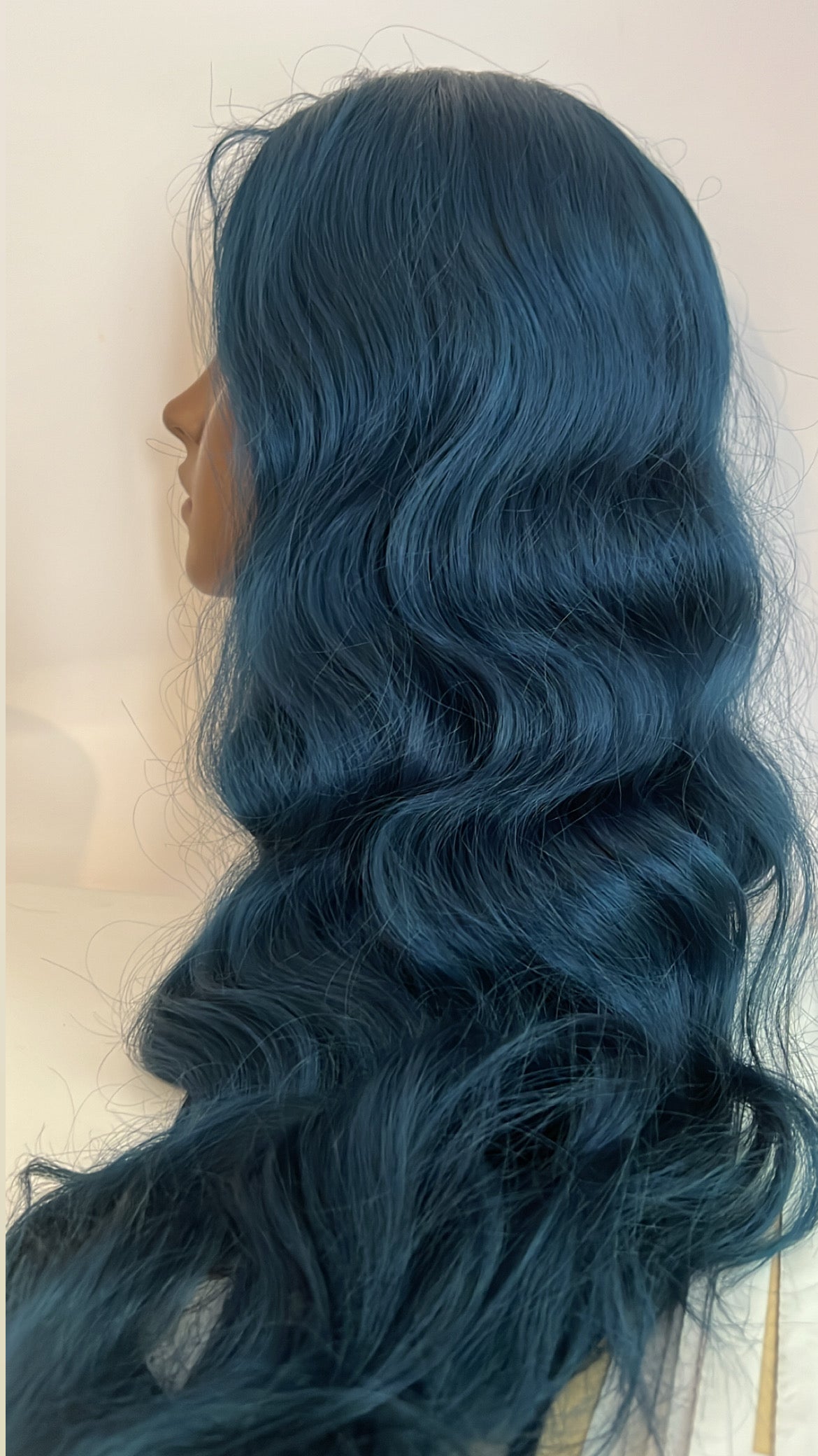 blue wavy wig on mannequin head