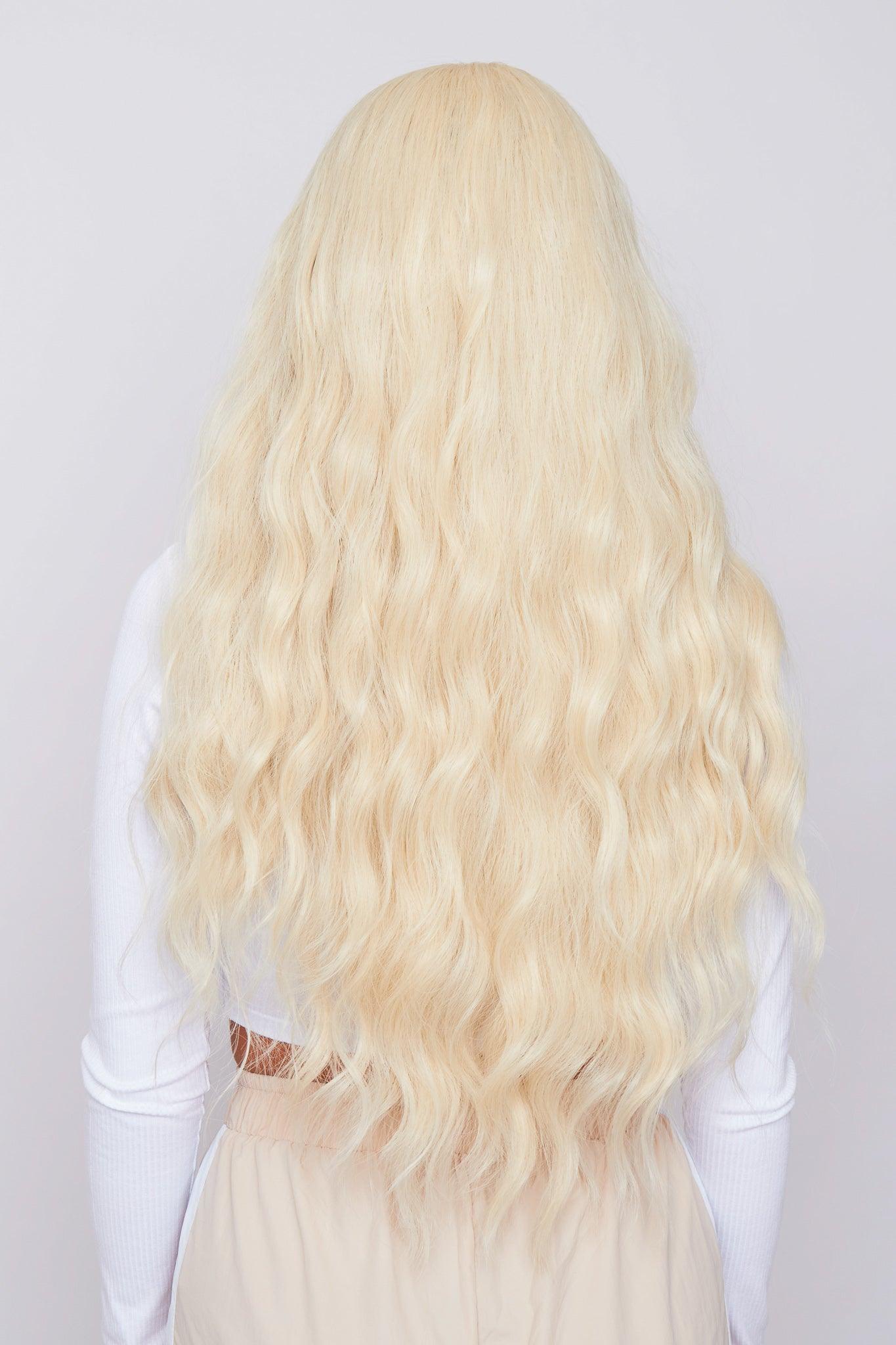 bleach blonde wig long and wavy being worn by girl form hair company pbeauty hair