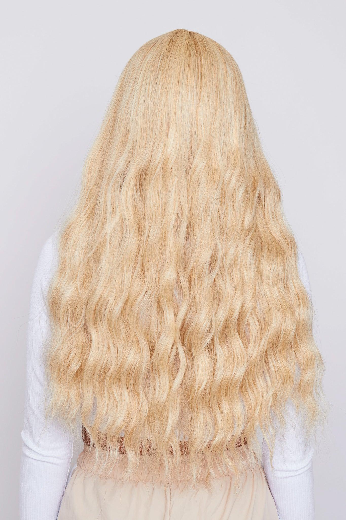 girl wearing long wavy bleach blonde wig