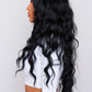 black long wavy synthetic wig from pbeauty hair being worn by woman