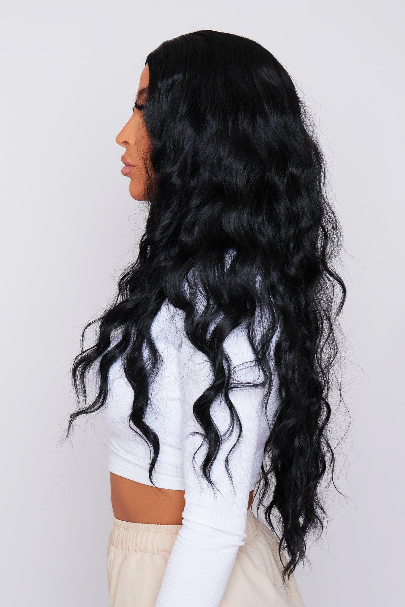 black long wavy synthetic wig from pbeauty hair being worn by woman